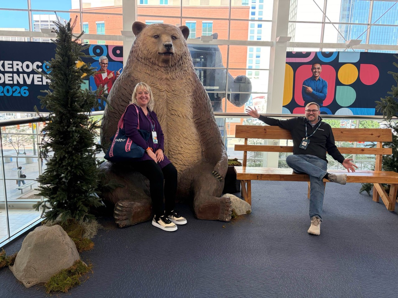 Luke and Lara posing with the Bears sculpture at the Colorado Convention Center