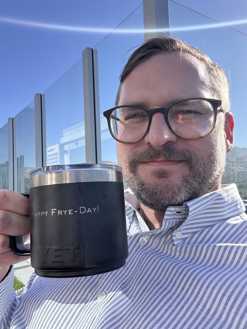 Luke Frye holding his Happy Frye-Day! YETI mug